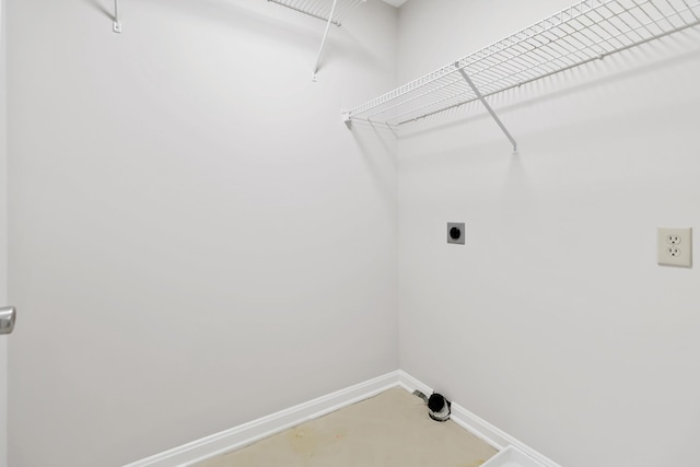 laundry area with laundry area, baseboards, and hookup for an electric dryer