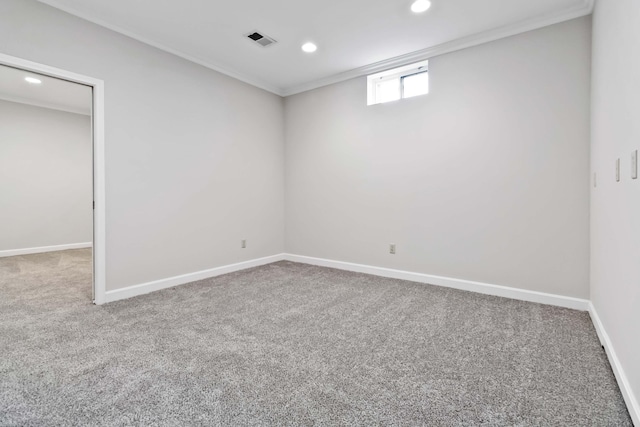 basement featuring carpet flooring, visible vents, and baseboards