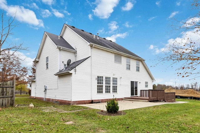 rear view of property with a patio area, a wooden deck, fence, and a yard