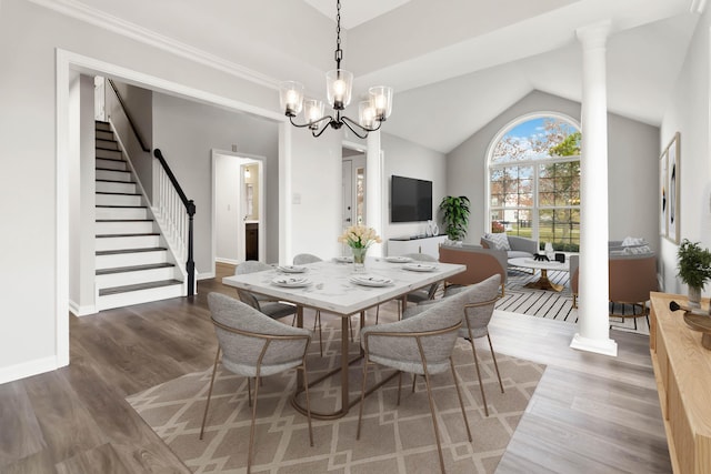 dining area with stairs, lofted ceiling, wood finished floors, and baseboards