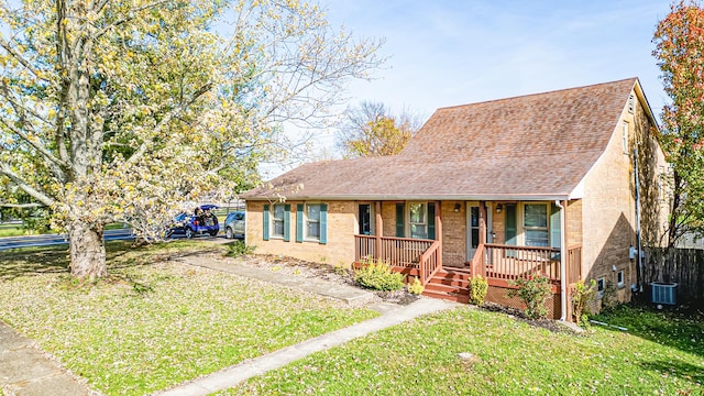 bungalow with a porch, a front yard, and central AC