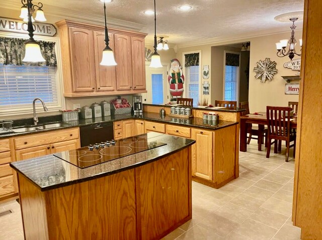 kitchen with decorative light fixtures, a kitchen island, kitchen peninsula, and a textured ceiling