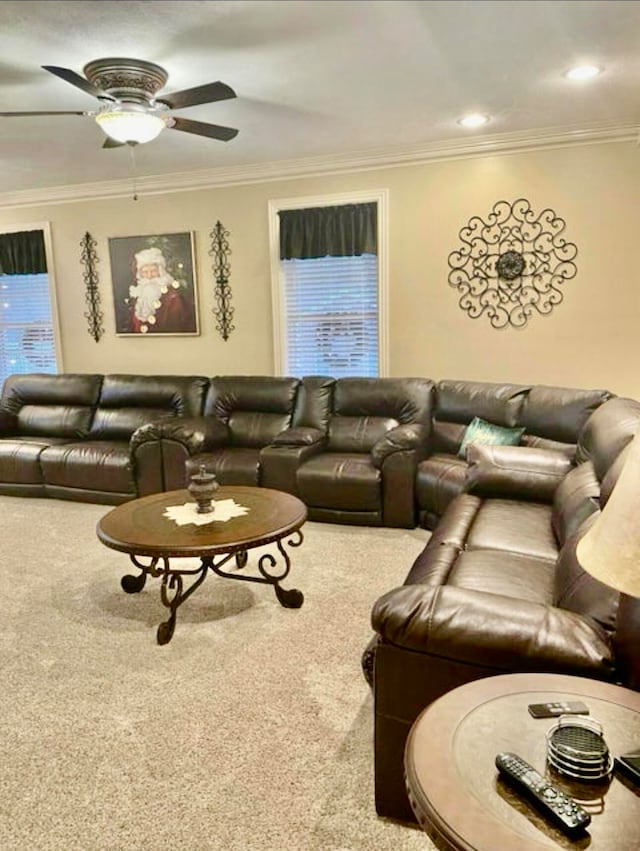 living room with carpet floors, ceiling fan, and ornamental molding