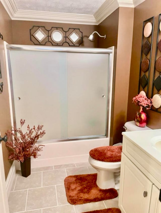 full bathroom with vanity, shower / bath combination with glass door, tile patterned floors, toilet, and ornamental molding