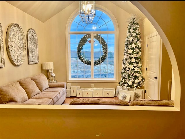 living area featuring vaulted ceiling and a notable chandelier