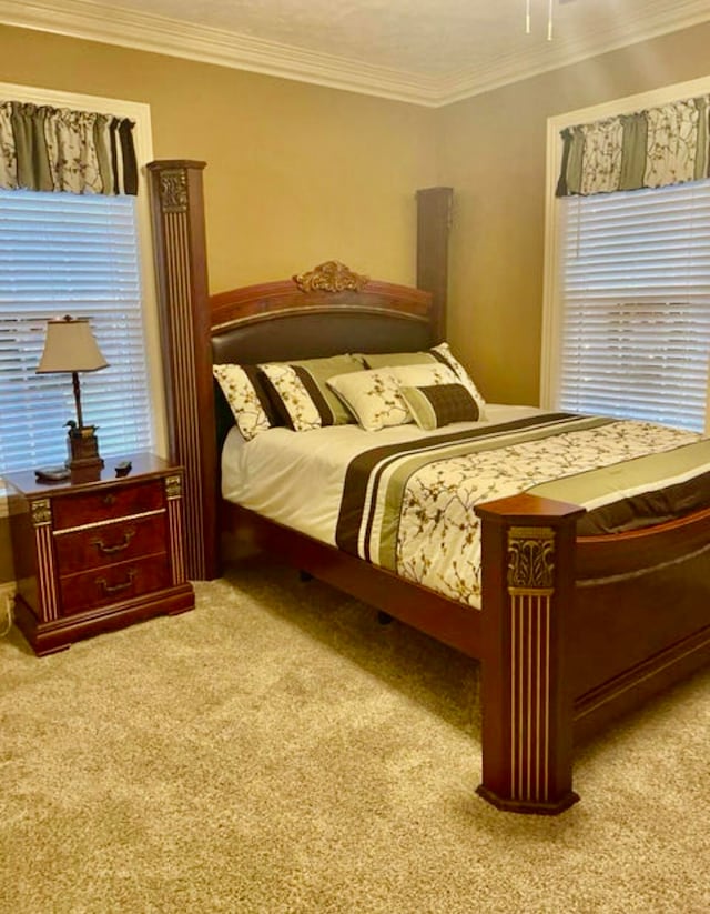 carpeted bedroom featuring ornamental molding