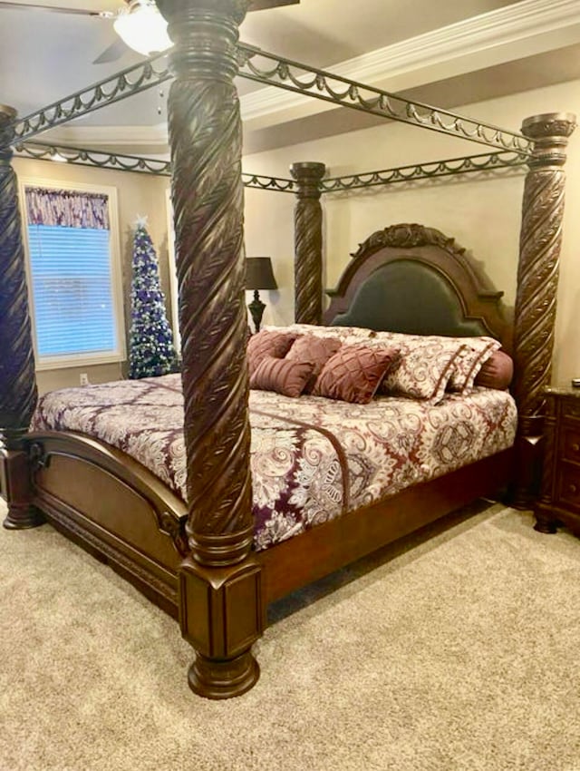 bedroom featuring carpet, ceiling fan, and crown molding