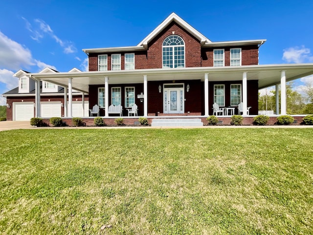 view of front of property with a porch, a garage, and a front yard