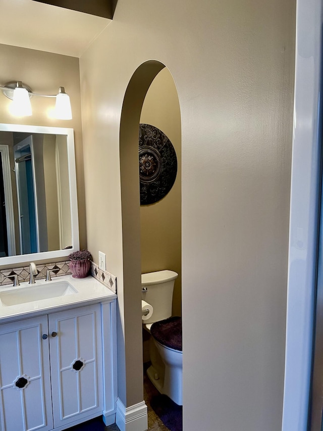 bathroom featuring vanity and toilet