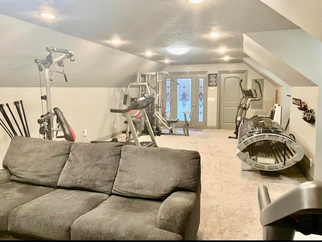 exercise area with carpet, lofted ceiling, and a textured ceiling