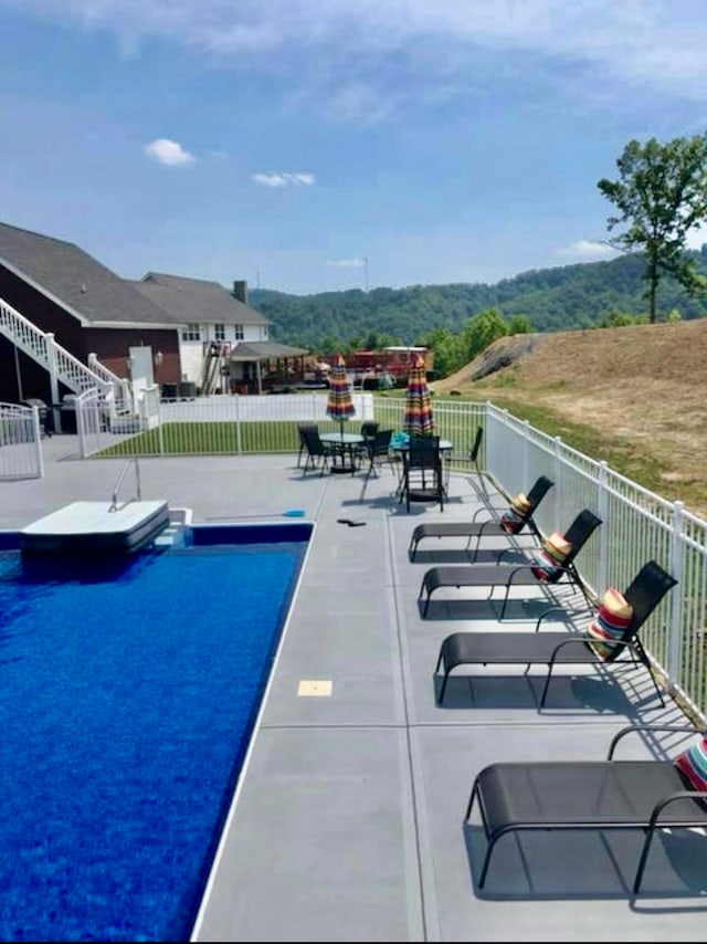 view of swimming pool with a patio area