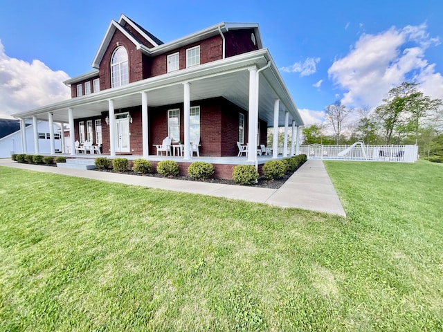 view of front facade with covered porch and a front lawn