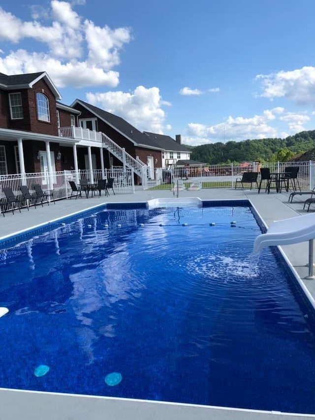 view of swimming pool with a water slide