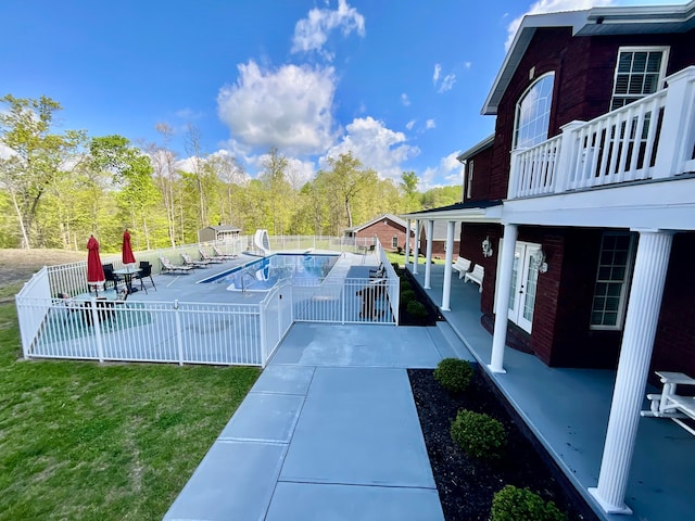 view of swimming pool with a lawn and a patio