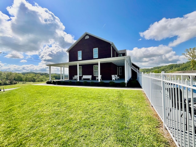 back of property featuring a yard