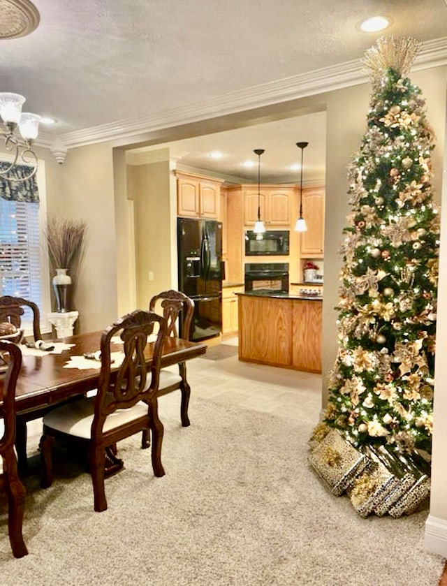 dining space featuring a chandelier, a textured ceiling, light colored carpet, and crown molding