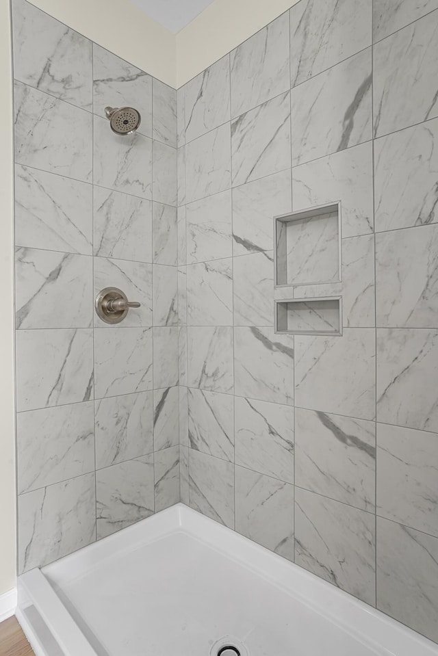 bathroom with a tile shower