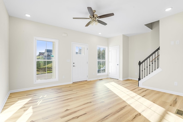 foyer entrance with light hardwood / wood-style floors and ceiling fan