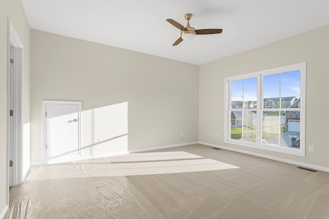 unfurnished room featuring ceiling fan and light colored carpet