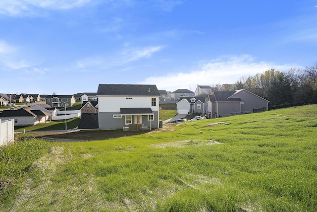 rear view of house with a yard