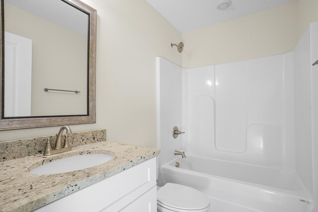 full bathroom with shower / tub combination, vanity, and toilet