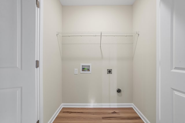 clothes washing area featuring electric dryer hookup, hardwood / wood-style floors, and hookup for a washing machine