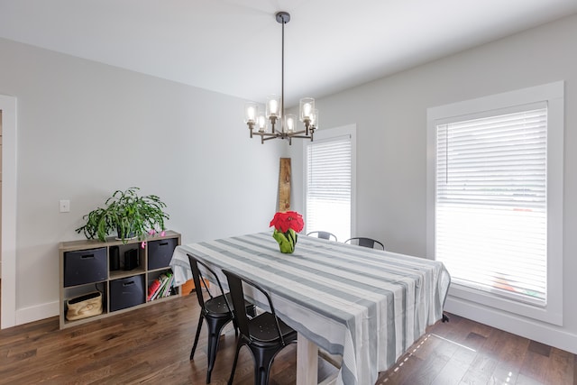 dining space featuring a notable chandelier and dark hardwood / wood-style flooring