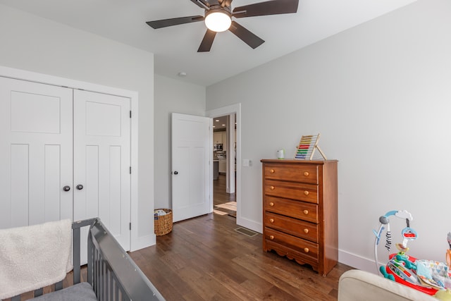 bedroom with ceiling fan, dark hardwood / wood-style flooring, and a closet