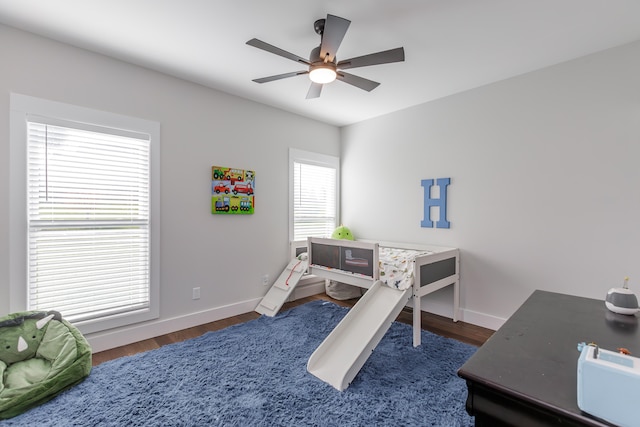 bedroom featuring dark hardwood / wood-style floors and ceiling fan