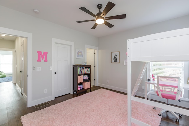 office with ceiling fan and dark wood-type flooring