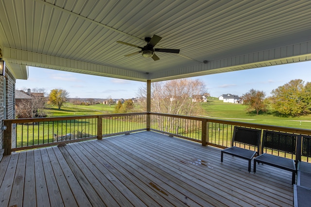 wooden deck with a yard and ceiling fan