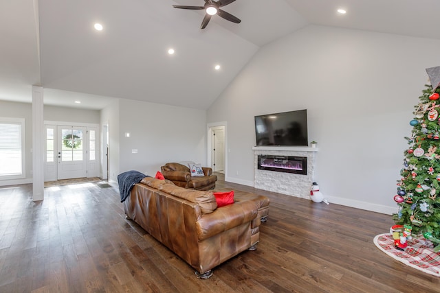 living room with a fireplace, ceiling fan, dark hardwood / wood-style flooring, and high vaulted ceiling