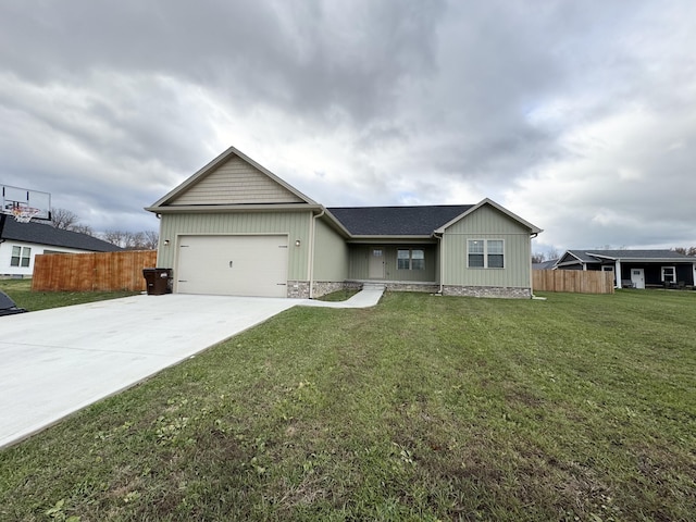 single story home with a garage and a front lawn