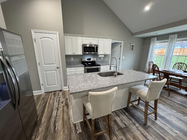 kitchen with white cabinetry, sink, stainless steel appliances, dark hardwood / wood-style flooring, and high vaulted ceiling