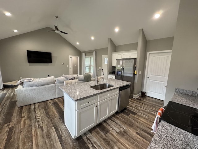 kitchen with dark wood-type flooring, white cabinets, a center island with sink, sink, and appliances with stainless steel finishes