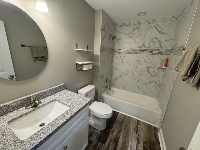 full bathroom featuring vanity, toilet, wood-type flooring, and tiled shower / bath