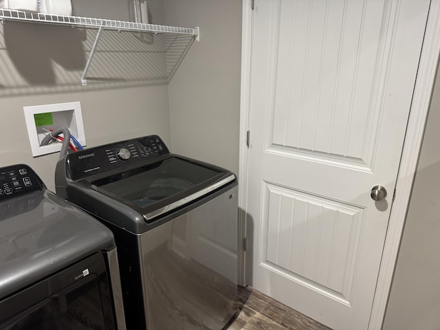 laundry room featuring wood-type flooring and washing machine and clothes dryer