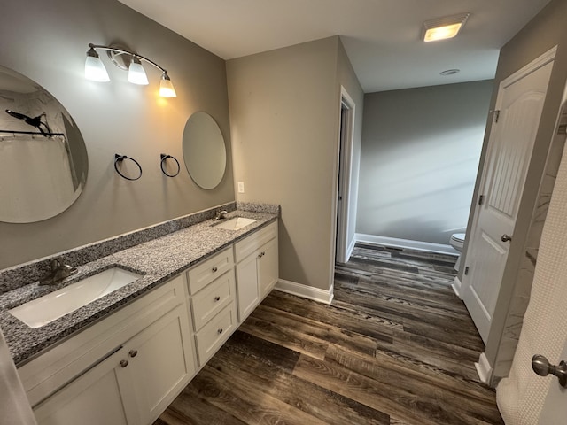 bathroom featuring hardwood / wood-style floors, vanity, and toilet