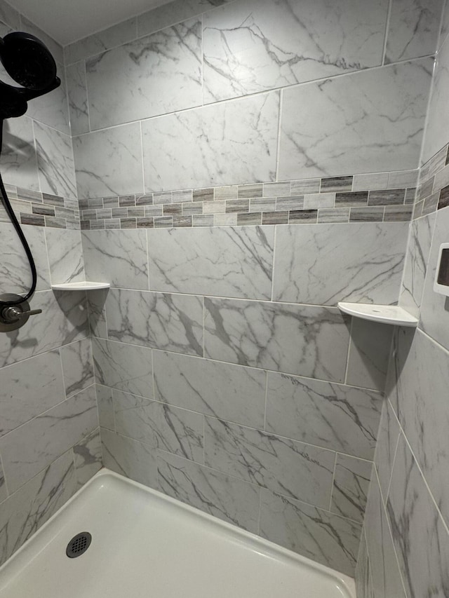 bathroom with a tile shower