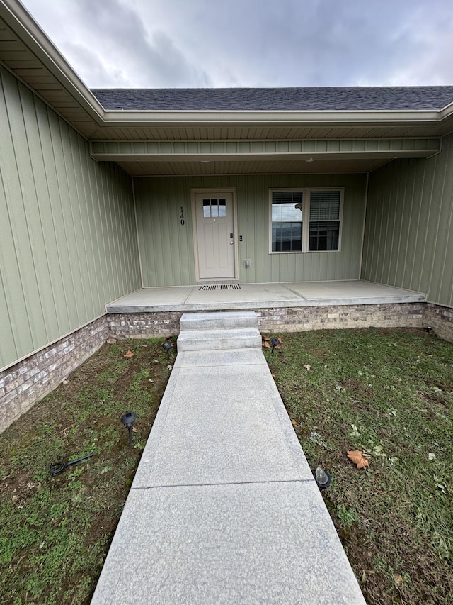 view of exterior entry featuring a porch