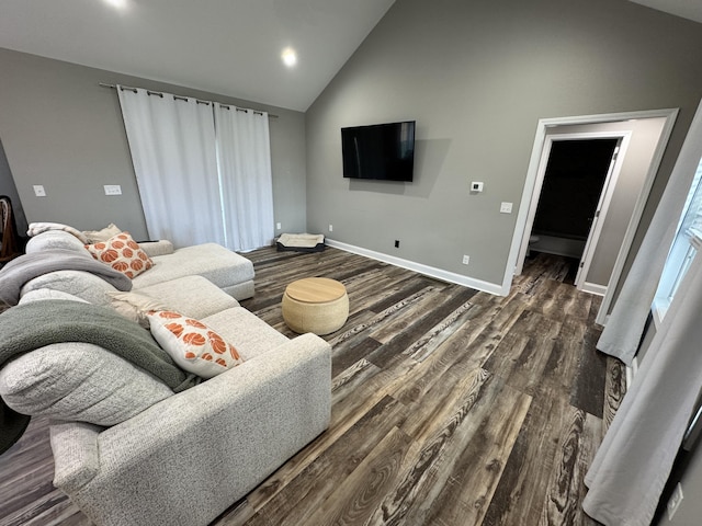 living room featuring dark hardwood / wood-style floors and high vaulted ceiling