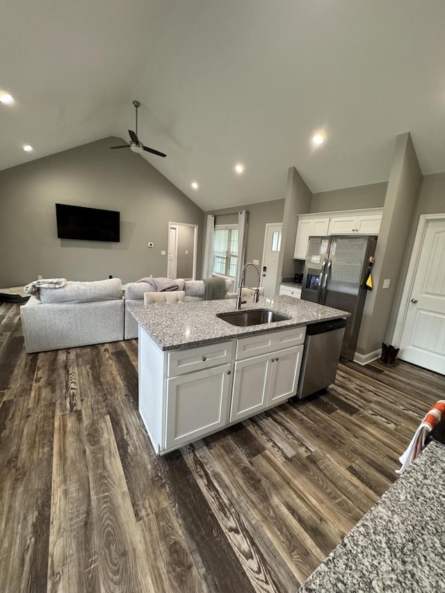 kitchen with sink, stainless steel appliances, dark hardwood / wood-style flooring, lofted ceiling, and white cabinets