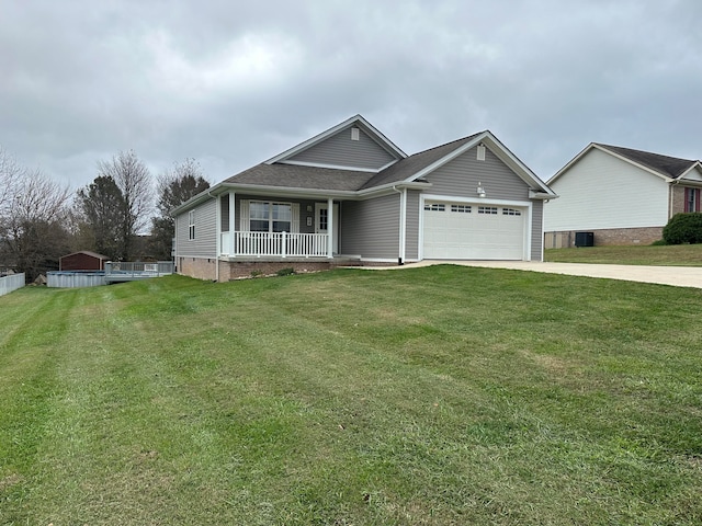 view of front of home featuring a garage, covered porch, and a front yard