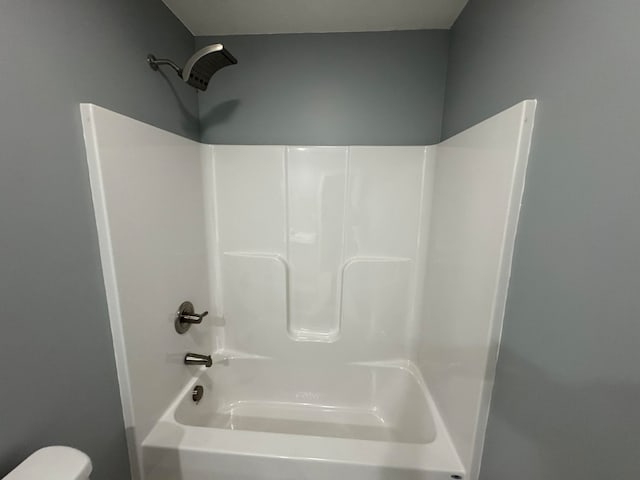 bathroom featuring toilet and tub / shower combination