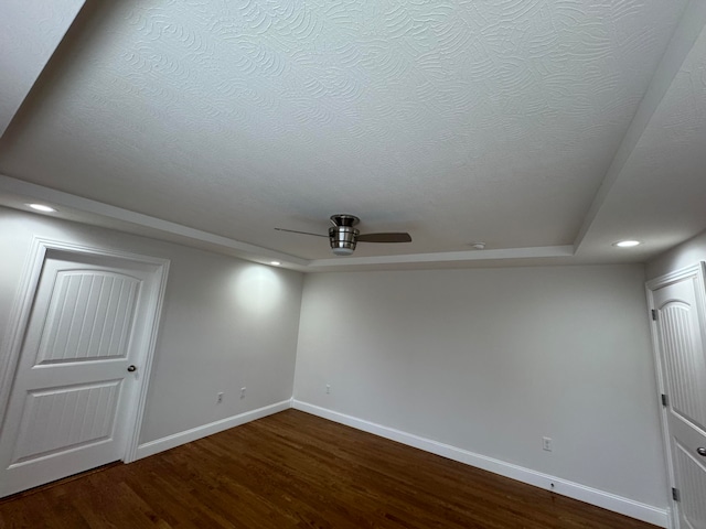 spare room featuring wood-type flooring, a textured ceiling, and ceiling fan