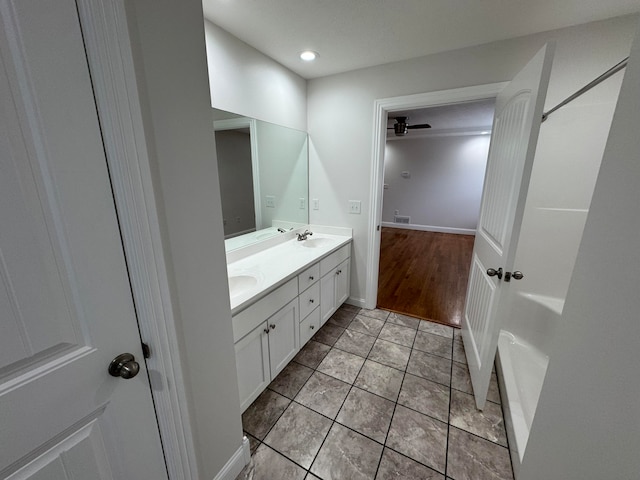 bathroom with ceiling fan, vanity, and wood-type flooring