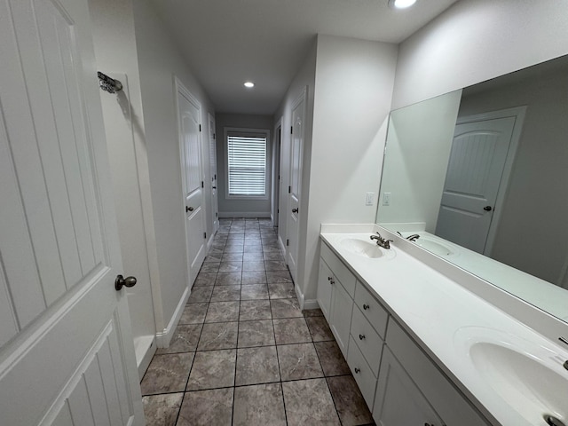 bathroom featuring tile patterned flooring and vanity