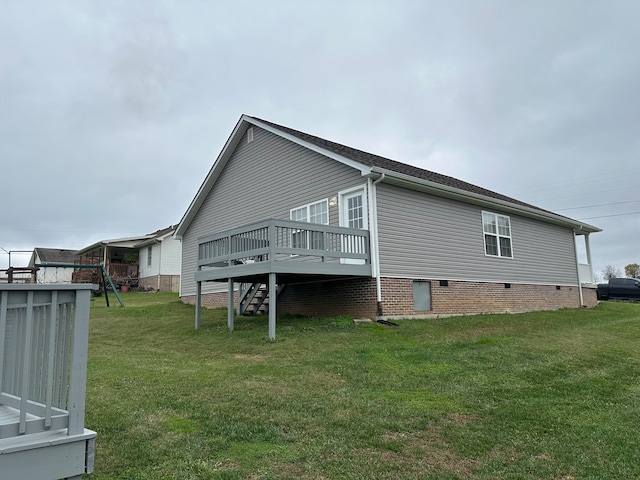 view of side of property with a lawn and a wooden deck