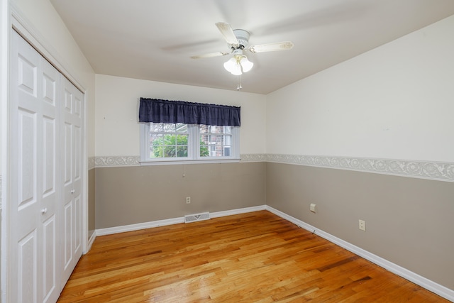 unfurnished bedroom featuring light wood-type flooring, a closet, and ceiling fan