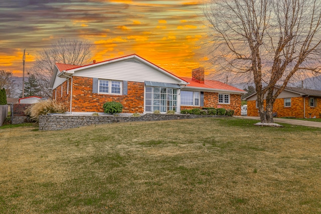 single story home featuring a yard